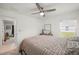 This bedroom features a ceiling fan, a window, a closet and minimalist decor at 21310 Quesada Ave, Port Charlotte, FL 33952