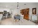 Inviting dining area featuring a round table, white chairs, and a charming hutch with seamless flow to the kitchen at 21310 Quesada Ave, Port Charlotte, FL 33952