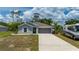 Charming single-story home with a spacious driveway and lush landscaping at 21310 Quesada Ave, Port Charlotte, FL 33952