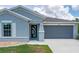 Charming home with a modern front door, well-manicured lawn, and a two-car garage at 21310 Quesada Ave, Port Charlotte, FL 33952