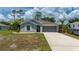 Beautiful single-Gathering home with a well-manicured lawn and modern gray exterior paint at 21310 Quesada Ave, Port Charlotte, FL 33952
