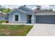 Charming home features a two car garage and an inviting front yard at 21310 Quesada Ave, Port Charlotte, FL 33952