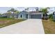 Charming single-Gathering home with a well-manicured lawn and modern gray exterior at 21310 Quesada Ave, Port Charlotte, FL 33952