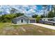Single-Gathering home with a well-manicured lawn and modern gray exterior at 21310 Quesada Ave, Port Charlotte, FL 33952