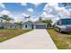 Charming single-story home featuring a long driveway, two-car garage and an RV parking pad at 21310 Quesada Ave, Port Charlotte, FL 33952