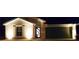 Inviting home exterior highlighted by elegant uplighting, enhancing the curb appeal at 21310 Quesada Ave, Port Charlotte, FL 33952