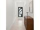 Bright foyer with decorative front door, tile flooring, and stylish console table at 21310 Quesada Ave, Port Charlotte, FL 33952