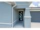 Close-up of modern front door showcasing unique design with covered porch at 21310 Quesada Ave, Port Charlotte, FL 33952