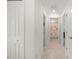 Bright hallway shows the entryway to a bathroom with a flamingo themed shower curtain at 21310 Quesada Ave, Port Charlotte, FL 33952