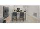 Bright kitchen featuring white cabinets, stainless steel appliances, and a quartz countertop island with barstool seating at 21310 Quesada Ave, Port Charlotte, FL 33952
