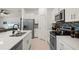 Contemporary kitchen with white cabinets, stainless appliances, and large island at 21310 Quesada Ave, Port Charlotte, FL 33952