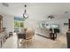 Bright open-concept living space flowing from the dining area, featuring comfortable seating and a large sliding glass door at 21310 Quesada Ave, Port Charlotte, FL 33952