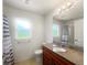 Clean bathroom with tile floors, granite countertop, toilet, window, and shower at 2336 Redfern St, Port Charlotte, FL 33948
