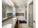 Modern bathroom with double vanity, granite countertops, a bathtub, and tile accents at 2336 Redfern St, Port Charlotte, FL 33948