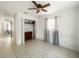 Bedroom featuring tile floors, a ceiling fan, a window with curtains, and a built-in closet with dresser at 2336 Redfern St, Port Charlotte, FL 33948