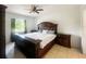 Spacious bedroom featuring a ceiling fan, dark furniture and a sunny window at 2336 Redfern St, Port Charlotte, FL 33948