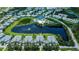 Stunning aerial view of a community with well-manicured landscaping, a serene pond, and community amenities at 25511 Heritage Lake Blvd # 8, Punta Gorda, FL 33983