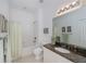 Well-lit bathroom features a shower-tub combo, large mirror, and vanity at 25511 Heritage Lake Blvd # 8, Punta Gorda, FL 33983