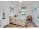 Comfortable bedroom features wood floors, large window, and ample natural light at 25511 Heritage Lake Blvd # 8, Punta Gorda, FL 33983