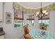 Cozy breakfast nook with chandelier, window treatments, and views of the outdoors at 25511 Heritage Lake Blvd # 8, Punta Gorda, FL 33983