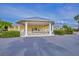A clubhouse with white pillars and manicured greenery at 25511 Heritage Lake Blvd # 8, Punta Gorda, FL 33983