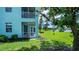 A ground floor exterior view with a screened lanai surrounded by lush green lawn at 25511 Heritage Lake Blvd # 8, Punta Gorda, FL 33983