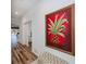 Hallway with wood floors and an ornate plant art piece to give a sense of home at 25511 Heritage Lake Blvd # 8, Punta Gorda, FL 33983