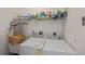 This laundry room offers an efficient space with a washer and dryer and overhead shelving at 25511 Heritage Lake Blvd # 8, Punta Gorda, FL 33983