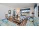 Spacious and inviting living room with hardwood floors, comfortable seating, and scenic views of the lake at 25511 Heritage Lake Blvd # 8, Punta Gorda, FL 33983