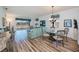 Bright living room with hardwood floors, stylish dining area, and large windows offering scenic views at 25511 Heritage Lake Blvd # 8, Punta Gorda, FL 33983
