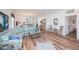 Light-filled living room with wood floors, comfortable seating, and access to the kitchen at 25511 Heritage Lake Blvd # 8, Punta Gorda, FL 33983