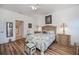 Comfortable main bedroom with wood floors and a ensuite bathroom at 25511 Heritage Lake Blvd # 8, Punta Gorda, FL 33983