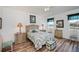 Cozy main bedroom with a ceiling fan, wood floors, and views of the water at 25511 Heritage Lake Blvd # 8, Punta Gorda, FL 33983