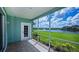 Relaxing screened-in patio with scenic lake views, lush greenery, and comfortable outdoor space at 25511 Heritage Lake Blvd # 8, Punta Gorda, FL 33983