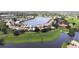 Aerial view of Seminole Lakes featuring a lake, a golf course and well-maintained landscaping, showcasing the community's charm at 26073 Feathersound Dr, Punta Gorda, FL 33955