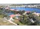 Aerial view of Seminole Lakes showcasing a lake, tennis courts, a pool, mature trees, and golf course at 26073 Feathersound Dr, Punta Gorda, FL 33955