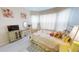 Bedroom with light colored walls and decor with curtains covering the windows at 26073 Feathersound Dr, Punta Gorda, FL 33955