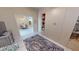 Bedroom with custom built-in shelving and a light colored rug overlooking the dining room and kitchen at 26073 Feathersound Dr, Punta Gorda, FL 33955