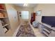 Bedroom with custom built-in shelving, a window and a light colored rug at 26073 Feathersound Dr, Punta Gorda, FL 33955