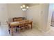 Dining room with a wooden table, chairs, and a view of the stainless steel refrigerator at 26073 Feathersound Dr, Punta Gorda, FL 33955