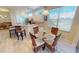Open floor plan eat-in area featuring a glass table, wicker chairs and a view to the kitchen at 26073 Feathersound Dr, Punta Gorda, FL 33955