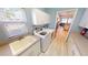 Bright laundry room featuring a utility sink, modern washer and dryer, ample storage cabinets, and wood flooring at 26073 Feathersound Dr, Punta Gorda, FL 33955