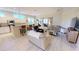 Open-concept living room featuring a modern kitchen, comfortable seating, and abundant natural light at 26073 Feathersound Dr, Punta Gorda, FL 33955