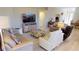 Cozy living room with comfortable seating, a large TV, and stylish decor for relaxation at 26073 Feathersound Dr, Punta Gorda, FL 33955