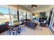 Comfortable sunroom with tile flooring, ample seating, and sliding glass doors overlooking the garden at 26073 Feathersound Dr, Punta Gorda, FL 33955