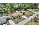 Aerial view of a residential home with a well-manicured lawn, a long driveway, and a nearby body of water at 3080 Saint James St, Port Charlotte, FL 33952