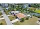 Aerial view of a single-Gathering home with a brown roof, a long driveway, and lush landscaping at 3080 Saint James St, Port Charlotte, FL 33952