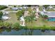 Back view of a lovely property near the tranquil canal with lush trees and a well-maintained yard at 3080 Saint James St, Port Charlotte, FL 33952