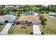 Aerial view showing the home's landscaping, attached garage and canal in a tranquil neighborhood setting at 3080 Saint James St, Port Charlotte, FL 33952