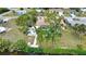 Back view of a beautiful home with mature trees near a canal and a refreshing pool at 3080 Saint James St, Port Charlotte, FL 33952
